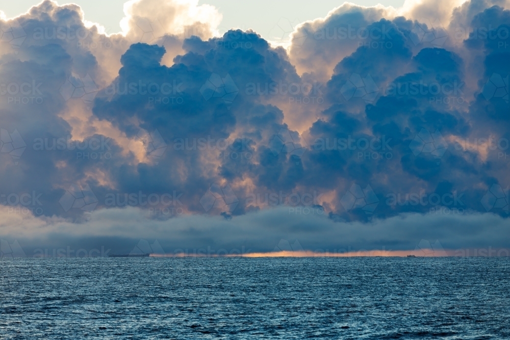 A stormy cloud front over the ocean at sunrise - Australian Stock Image