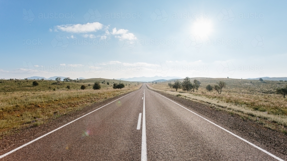 A straight sealed road leading towards the Flinders Ranges - Australian Stock Image
