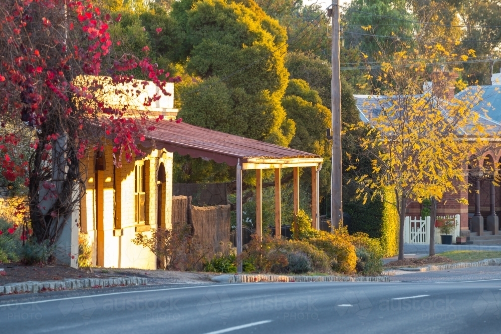 A street scene of old shopfronts and houses in Autumn - Australian Stock Image