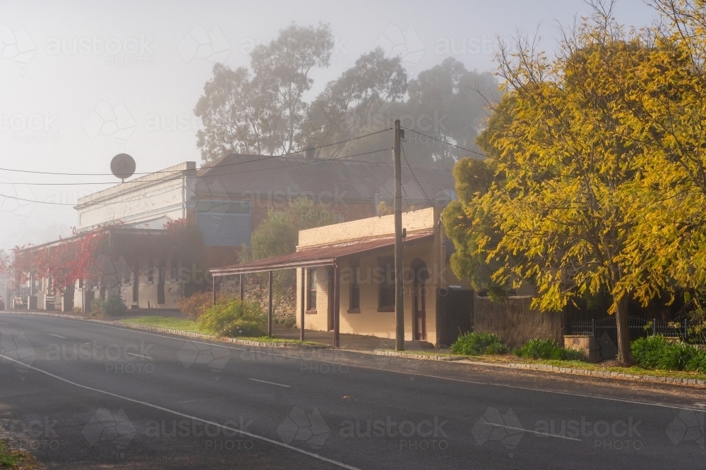 A streetscape of historic buildings on a foggy morning - Australian Stock Image