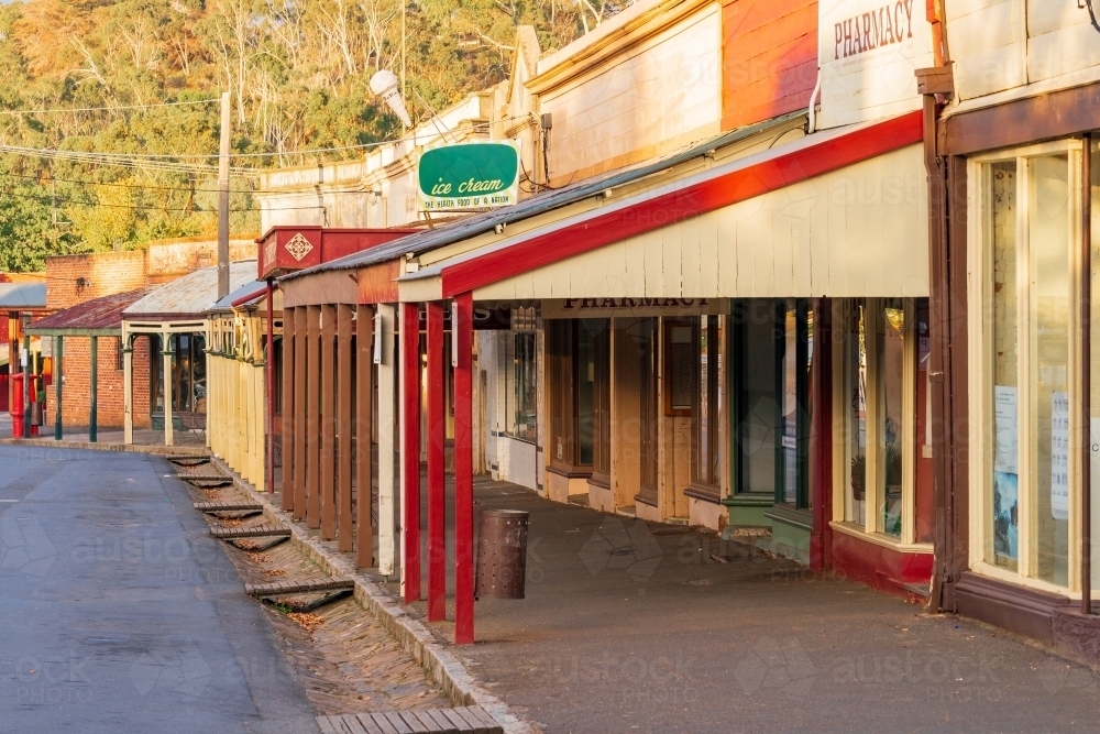 A streetscape of historic shop fronts with wide verandas - Australian Stock Image