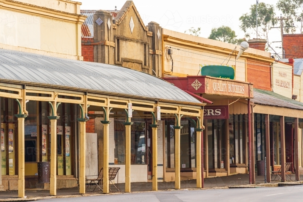 A streetscape of historic shop fronts with wide verandas - Australian Stock Image