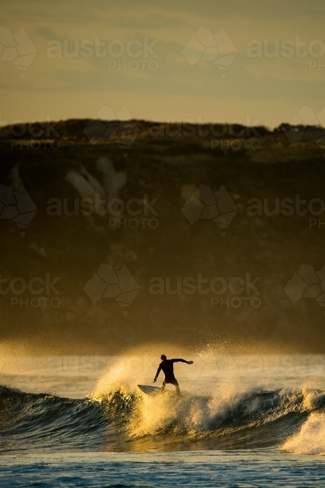 A surfer at first light on Woolamai Surf Beach. - Australian Stock Image