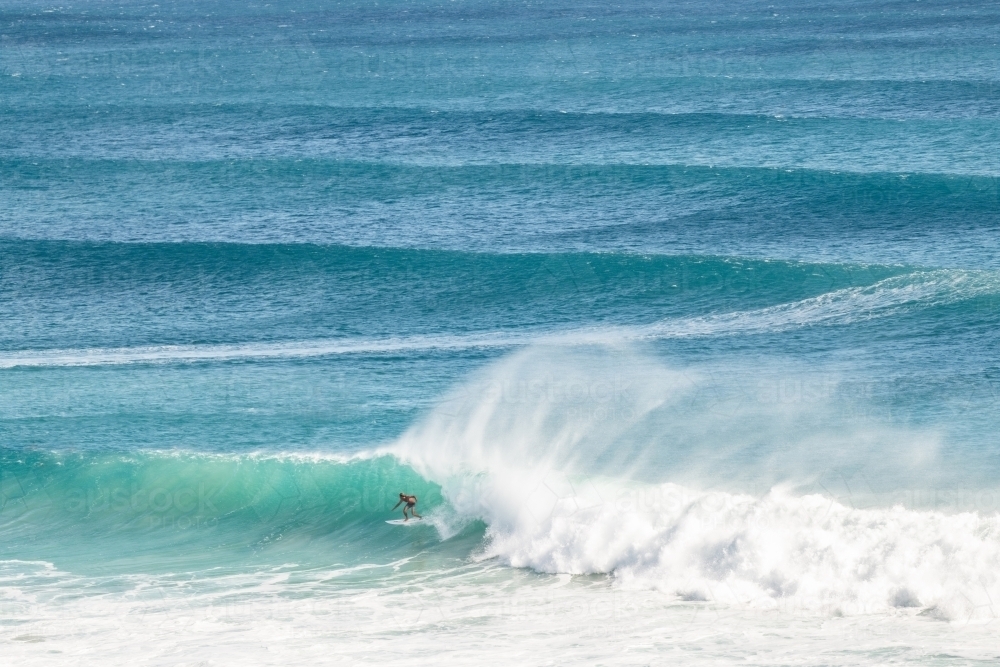 A surfer riding a long barrel wave on the Gold Coast - Australian Stock Image