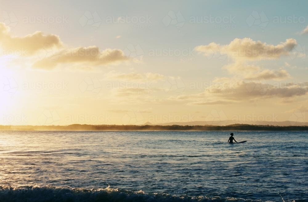 A surfer waiting on the water - Australian Stock Image