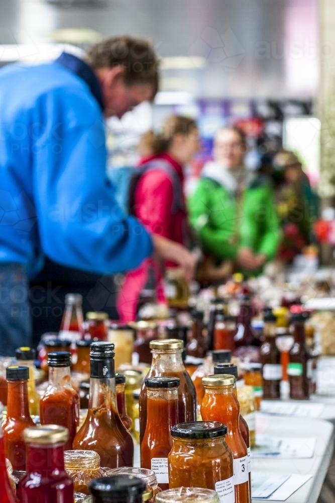 A table of bottle preserves and chutney being judged at a country fair - Australian Stock Image