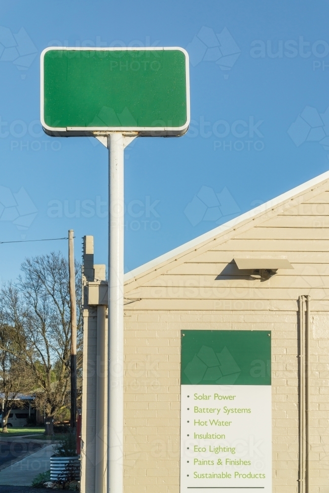 Corner Building Sign Example Image of A tall green sign mounted on the corner of a building ...