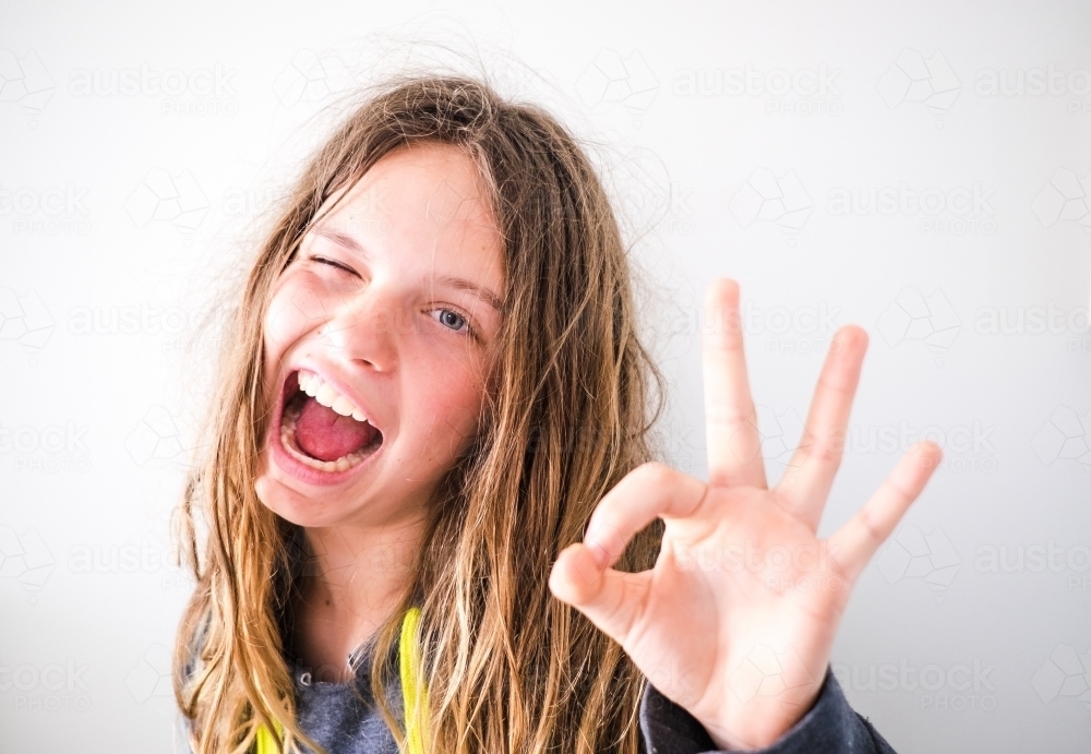 A teen girl gives a big wink - Australian Stock Image