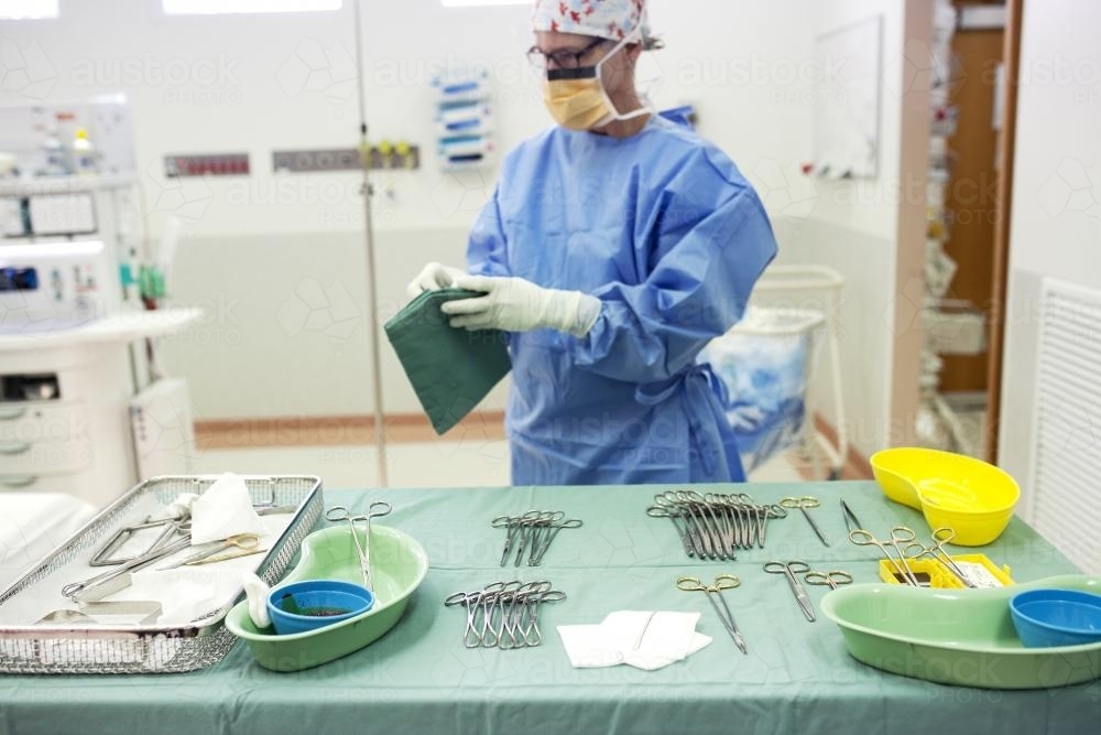 A theatre nurse preparing equipment for surgery in a hospital operating theatre - Australian Stock Image