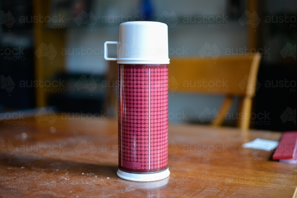 A thermos flask sits on a table during a renovation - Australian Stock Image