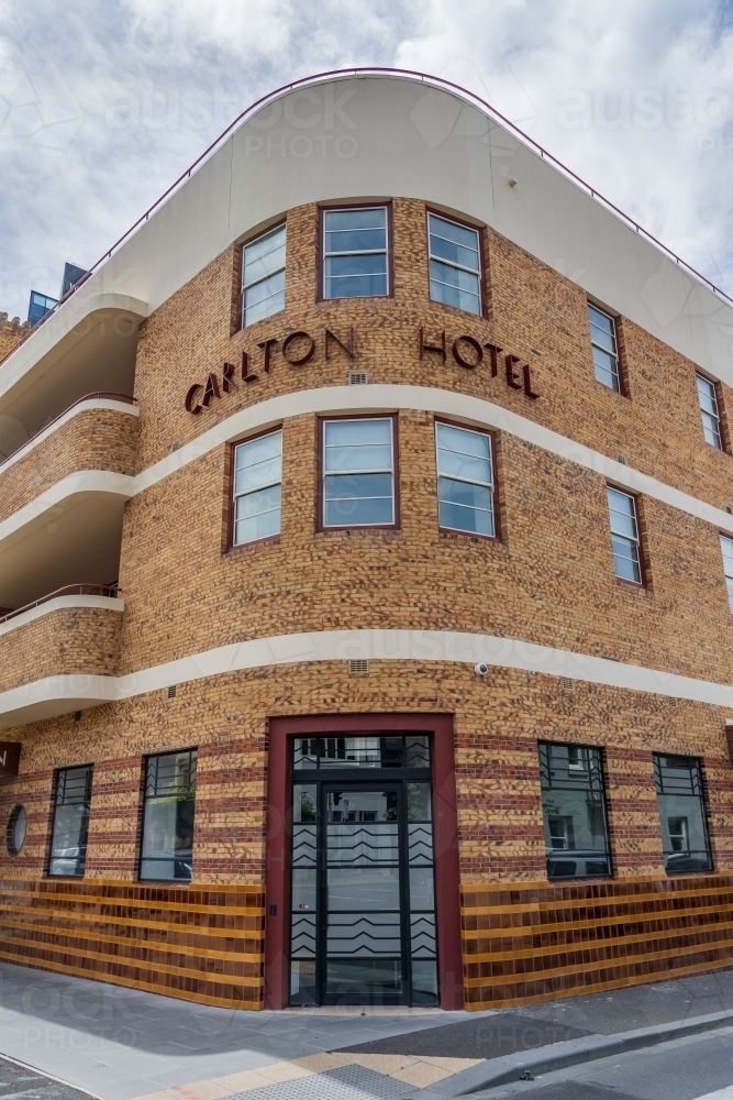 A three storey art deco hotel on a street corner - Australian Stock Image