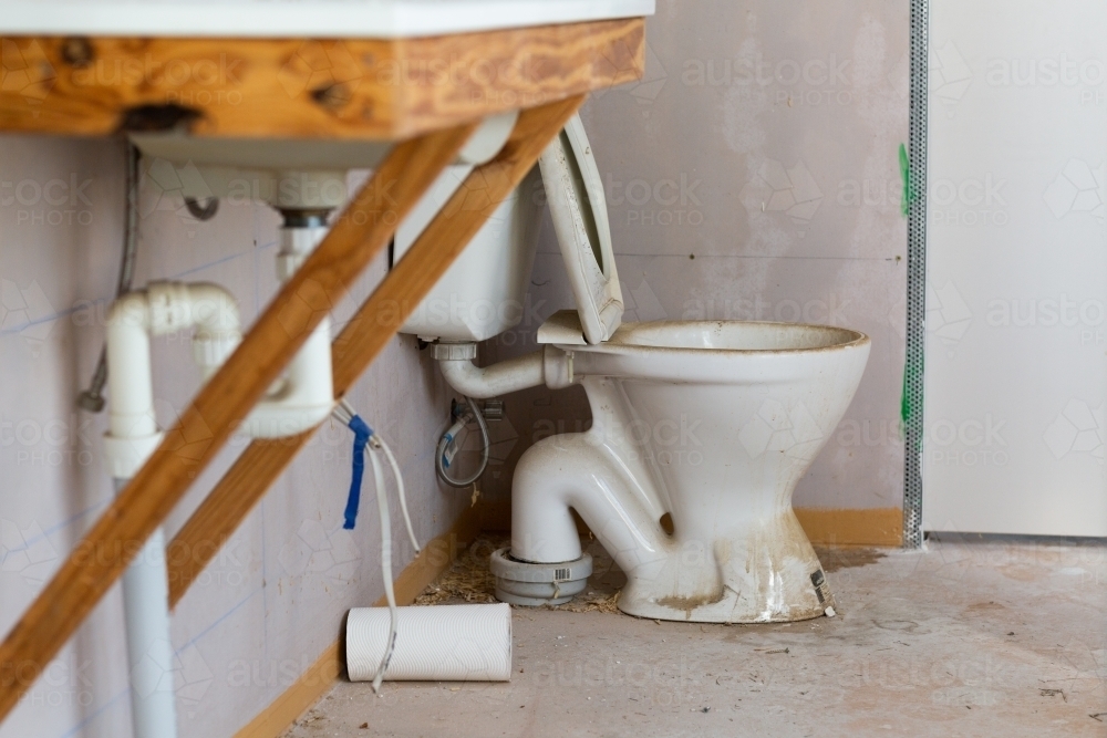 A toilet and basin in a bathroom during construction - Australian Stock Image