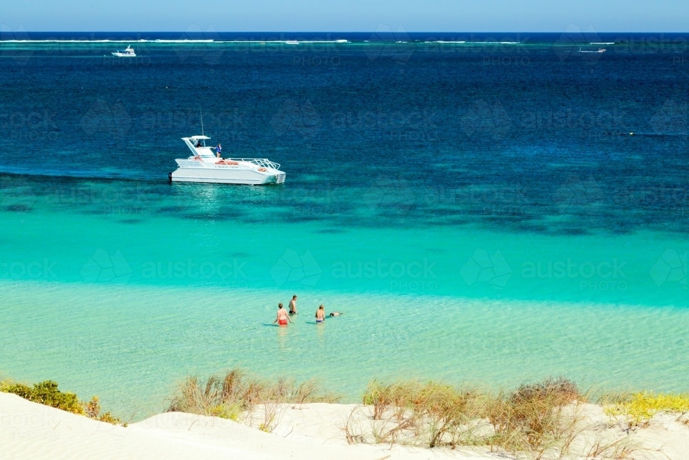 A tour boat cruising behind Ningaloo Reef, Western Australia - Australian Stock Image