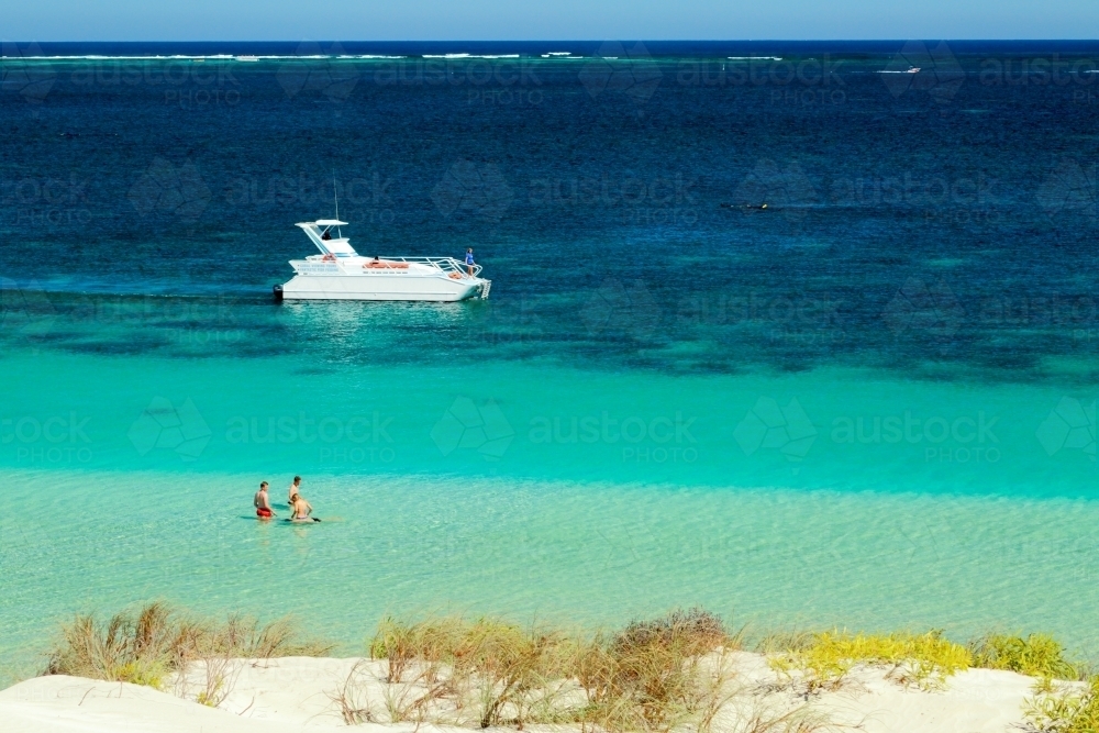 A tour boat cruising behind Ningaloo Reef, Western Australia - Australian Stock Image