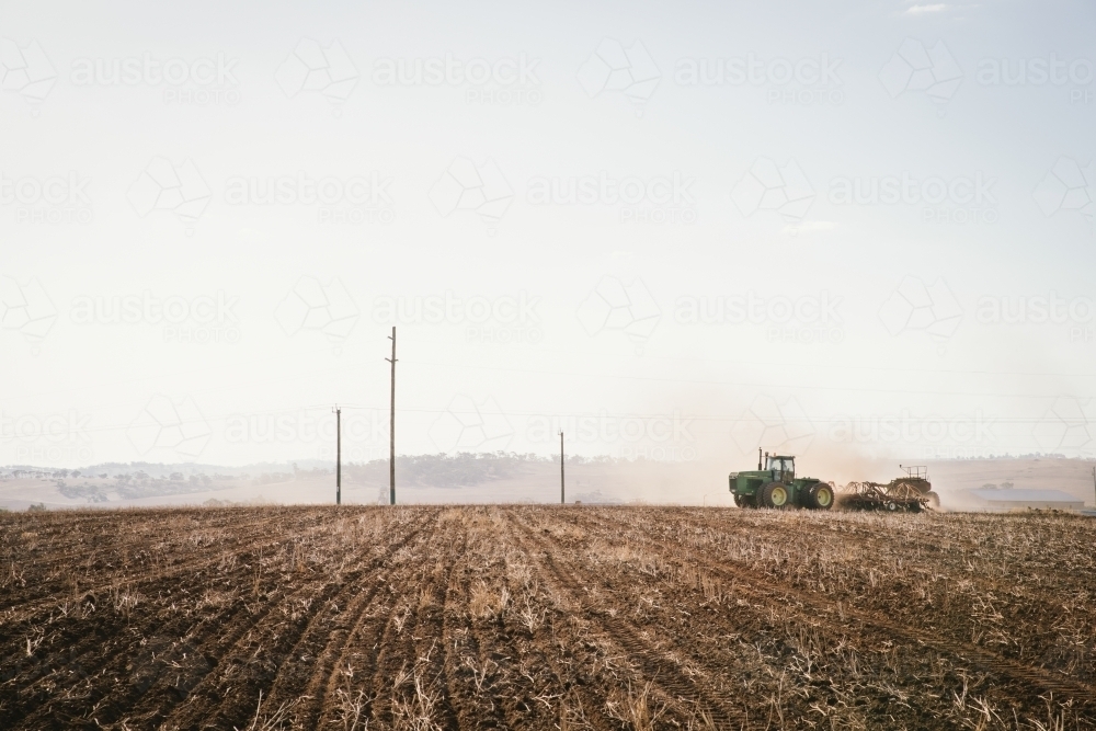 A tractor and seeder dry sowing wheat in the Avon Valley region of Western Australia - Australian Stock Image