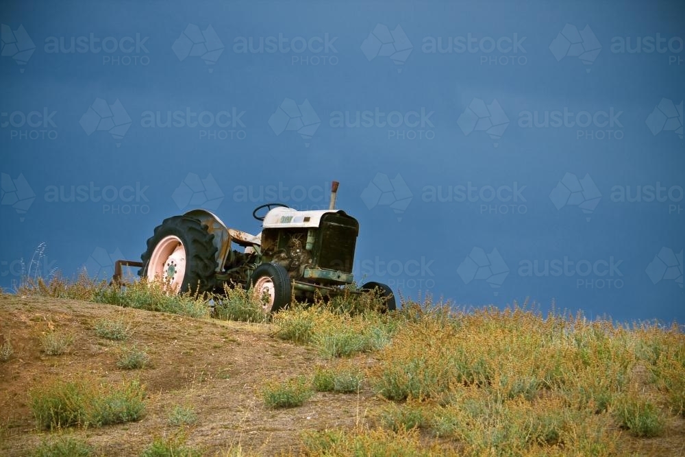 A tractor on a hill side - Australian Stock Image