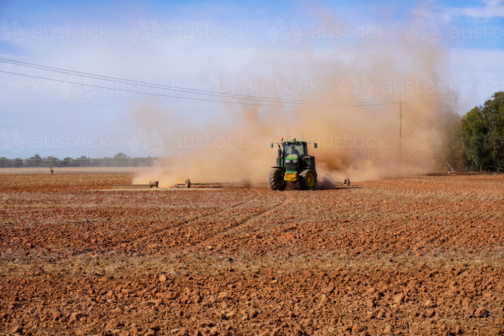 A tractor working the ground in preparation for sowing crops - Australian Stock Image