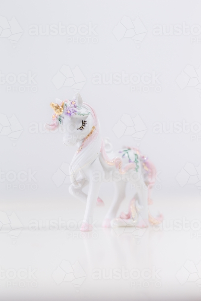 A unicorn figurine with a white background. - Australian Stock Image