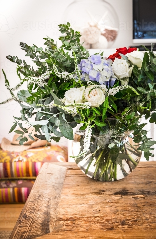 A vase of flowers on the coffee table in a country home - Australian Stock Image