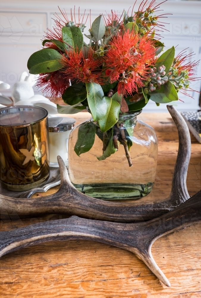 A vase of fresh picked New Zealand Christmas Bush on a coffee table - Australian Stock Image