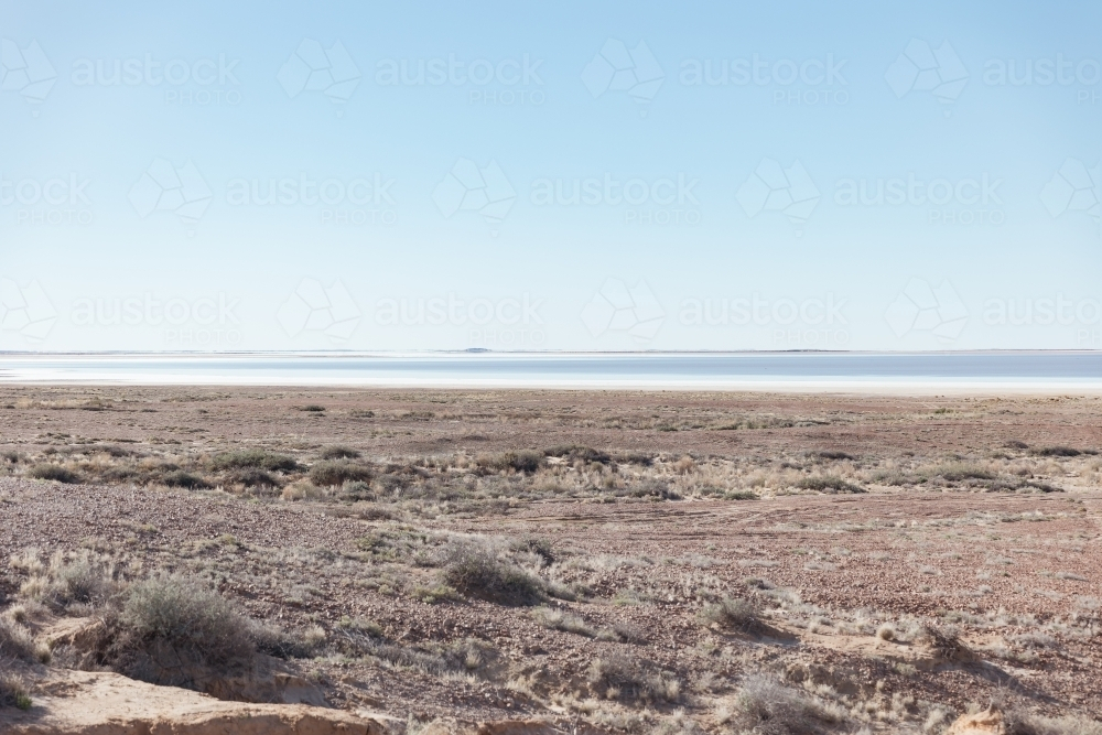 A vast, flat desert landscape under a clear blue sky. - Australian Stock Image