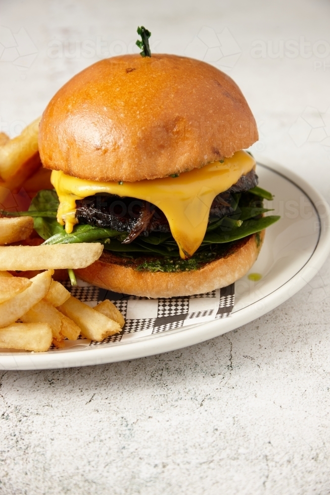 A vegetarian mushroom burger served with chips - Australian Stock Image