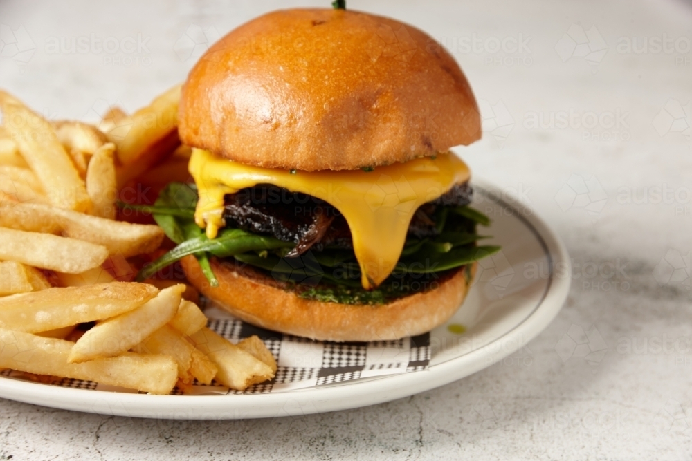 A vegetarian mushroom burger served with chips - Australian Stock Image