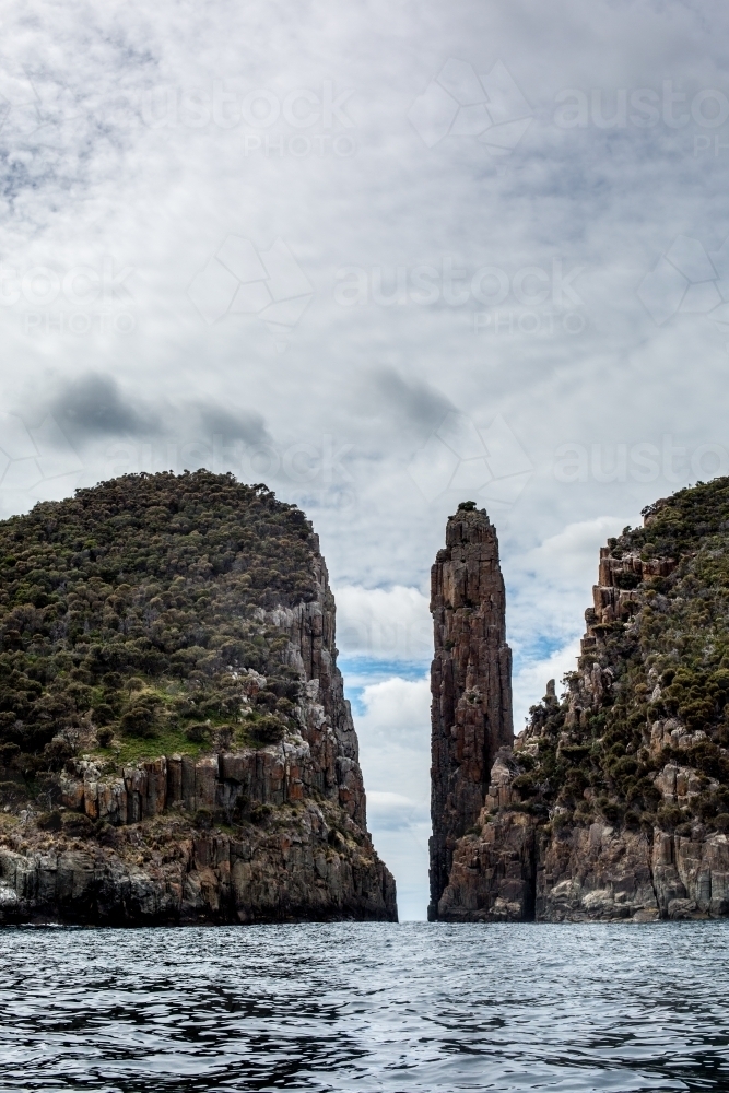 A view of Cape Hauy and the Candle Stick from the water - Australian Stock Image
