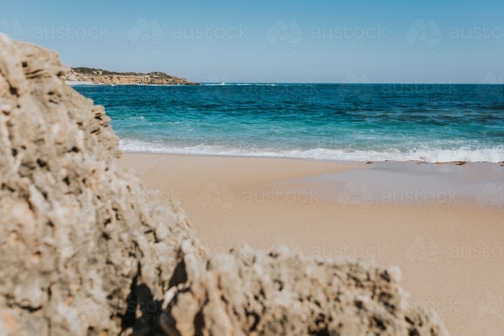 A view of the ocean from behind rocks - Australian Stock Image
