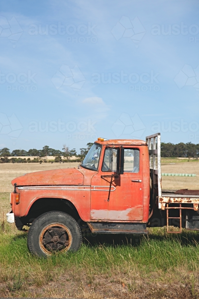 A vintage pick up truck sitting beside a rural road - Australian Stock Image