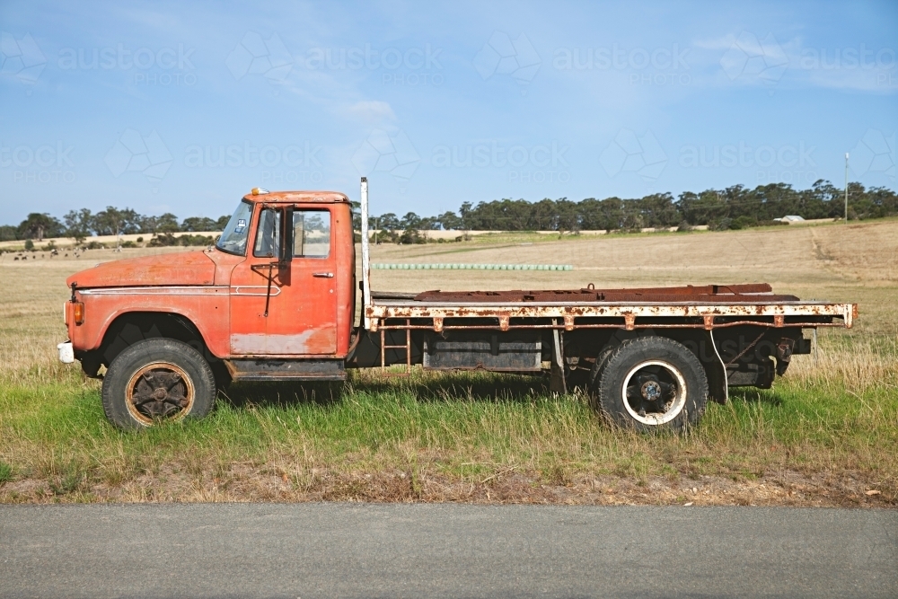 A vintage pick up truck sitting beside a rural road - Australian Stock Image