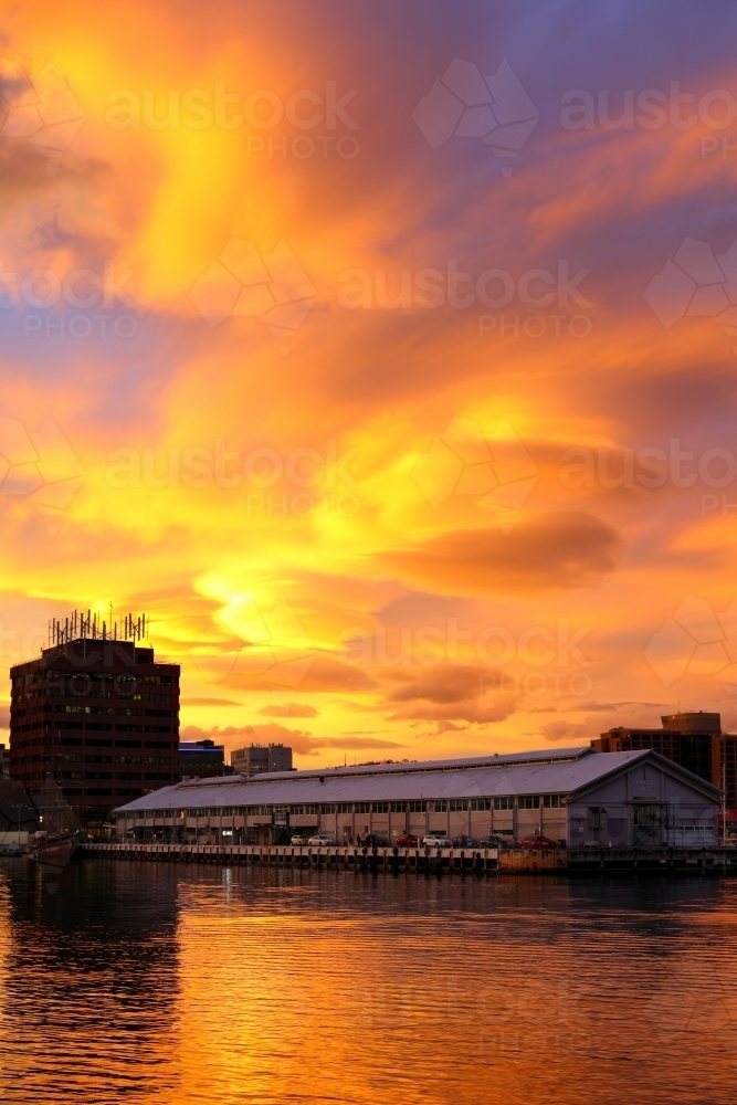 A vivid sunset over Elizabeth Street Pier and Sullivans Cove. - Australian Stock Image