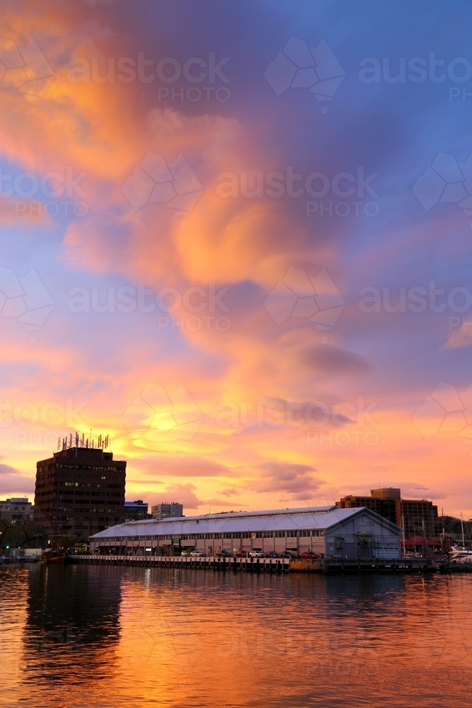 A vivid sunset over Elizabeth Street Pier and Sullivans Cove. - Australian Stock Image