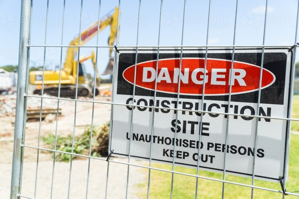 Image of A warning sign on the fence of a construction site Austockphoto