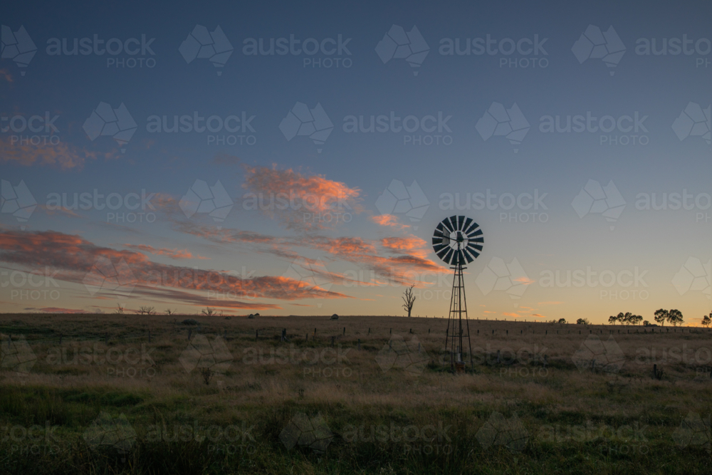 A windmill and a soft dawn sky - Australian Stock Image