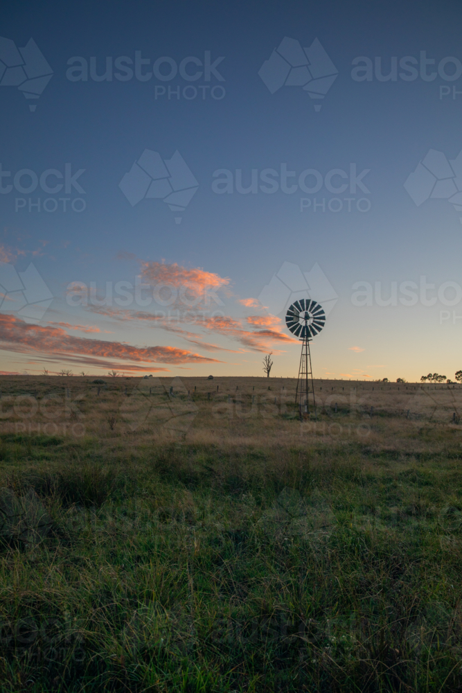 A windmill and a soft dawn sky - Australian Stock Image
