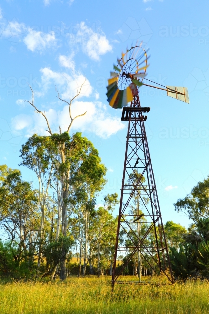 A windmill with blades painted like a rainbow. - Australian Stock Image