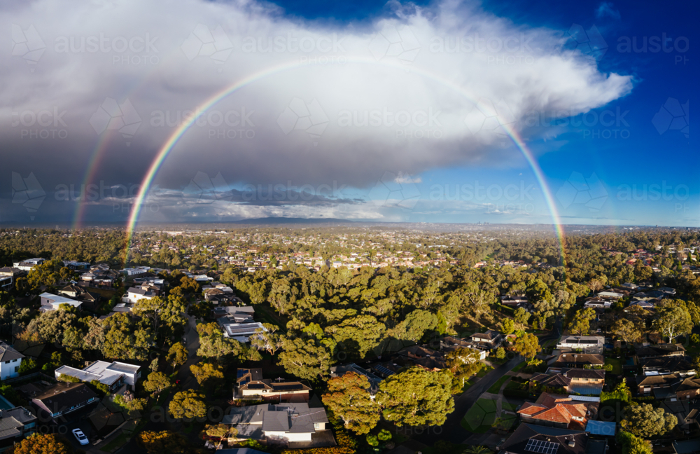 A winter's day storm and rainbow aerial view over the estate of Springthorpe near Bundoora - Australian Stock Image