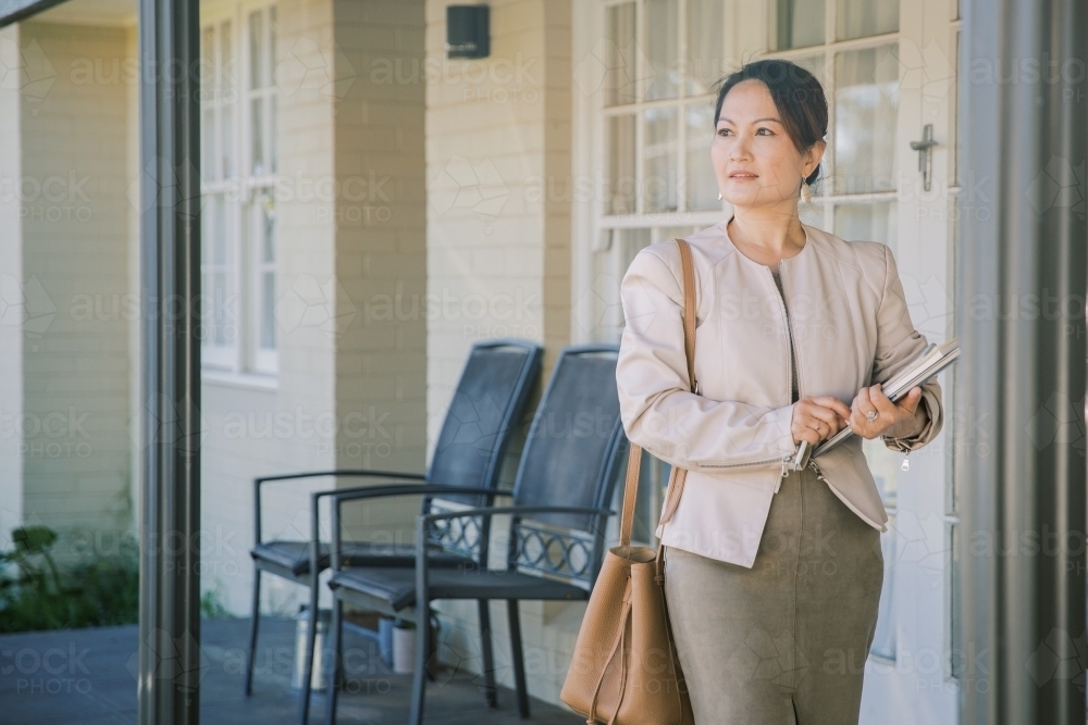A woman leaving home to go to work - Australian Stock Image