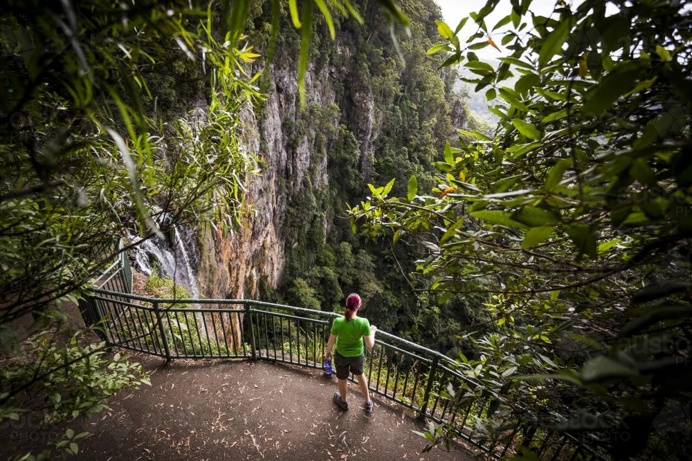 A woman overlooking a waterfall - Australian Stock Image