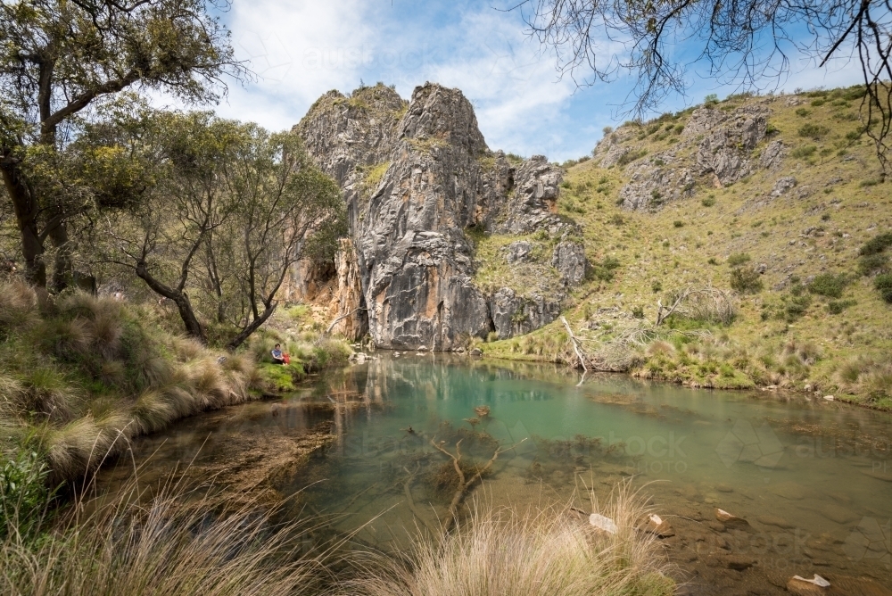 A Woman Resting by the Blue Holes in Kosciuszko - Australian Stock Image