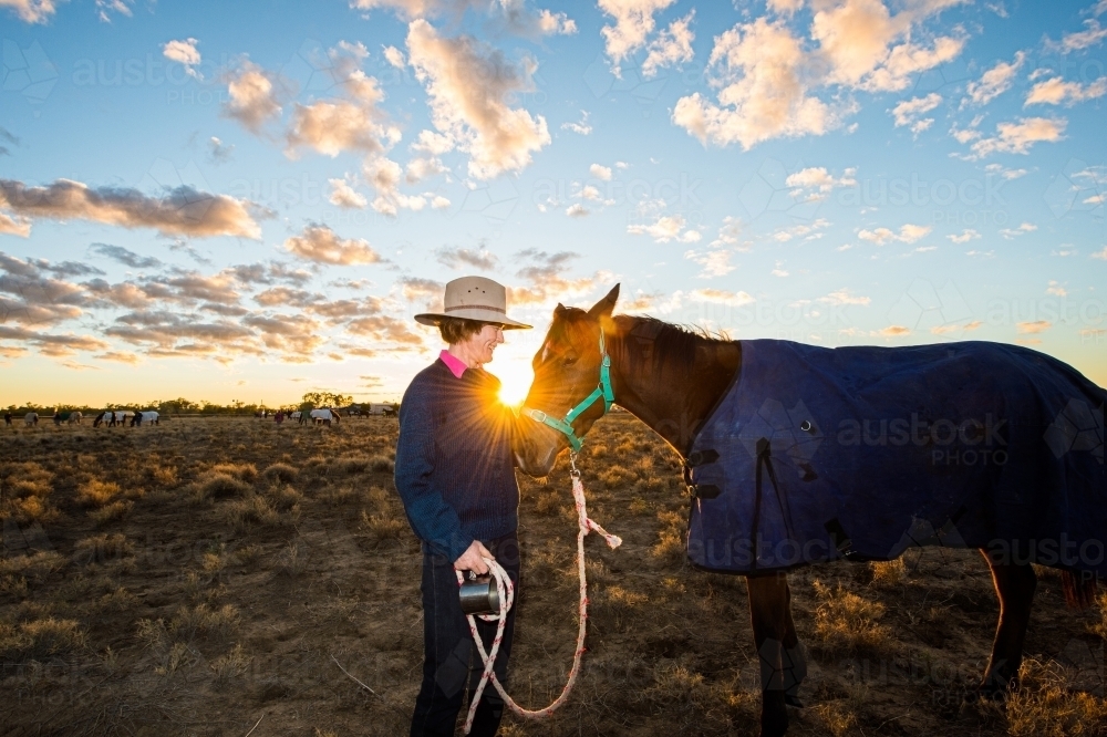 A woman with her horse before a country race meeting - Australian Stock Image