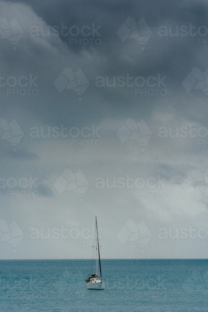 A yacht at sea with stormy skies - Australian Stock Image