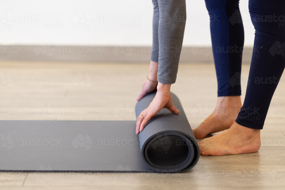 a yoga mat getting unrolled/rolled - Australian Stock Image