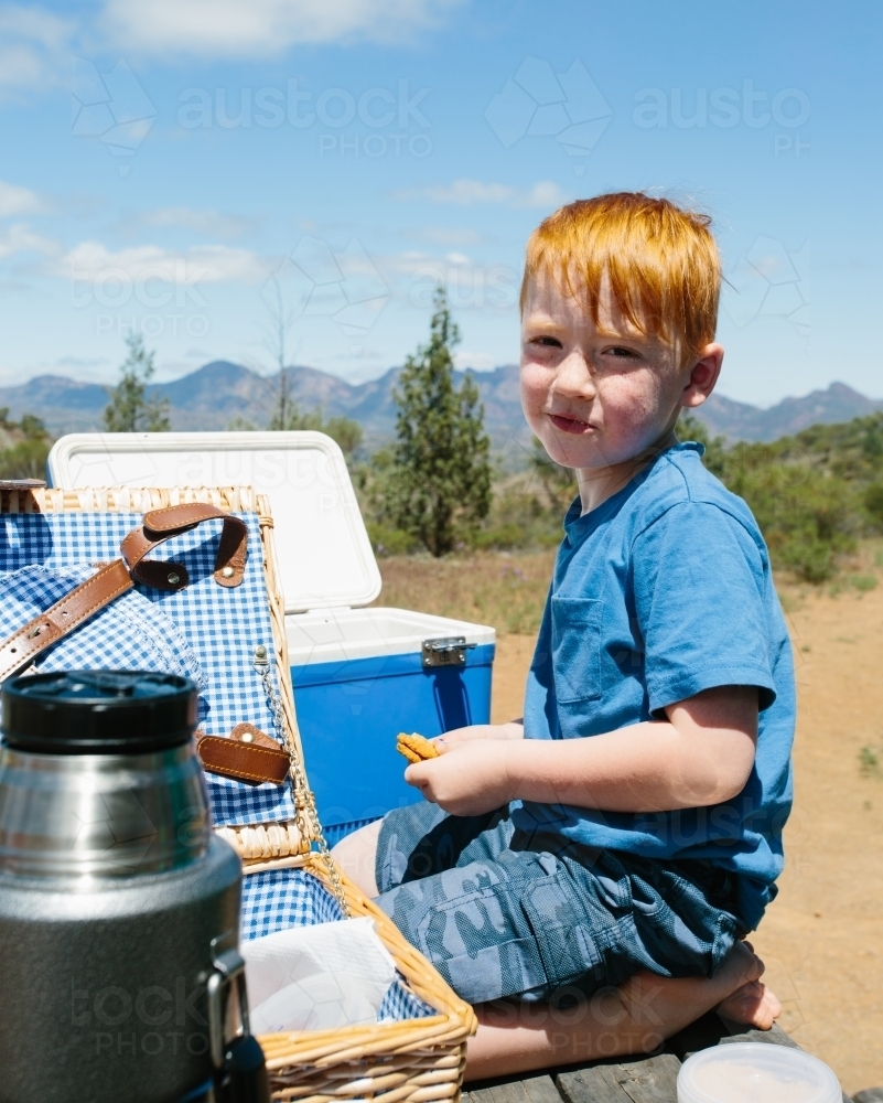 A young boy having a picnic at a rest area in a national park - Australian Stock Image