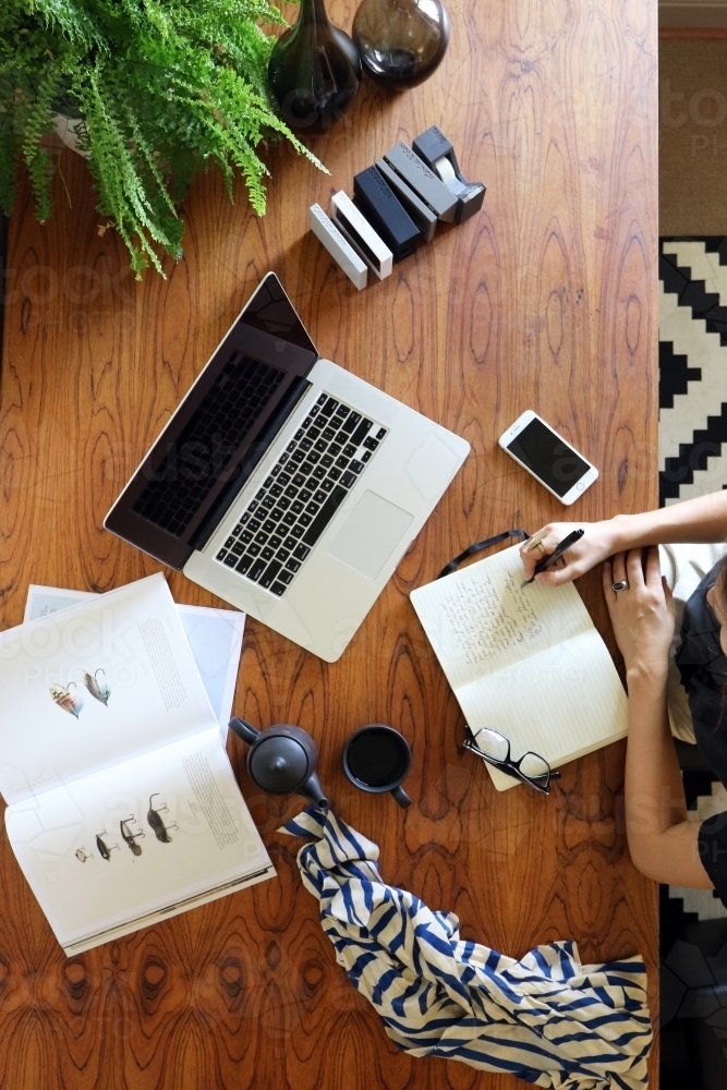 A young creative female worker at her office desk from above - Australian Stock Image