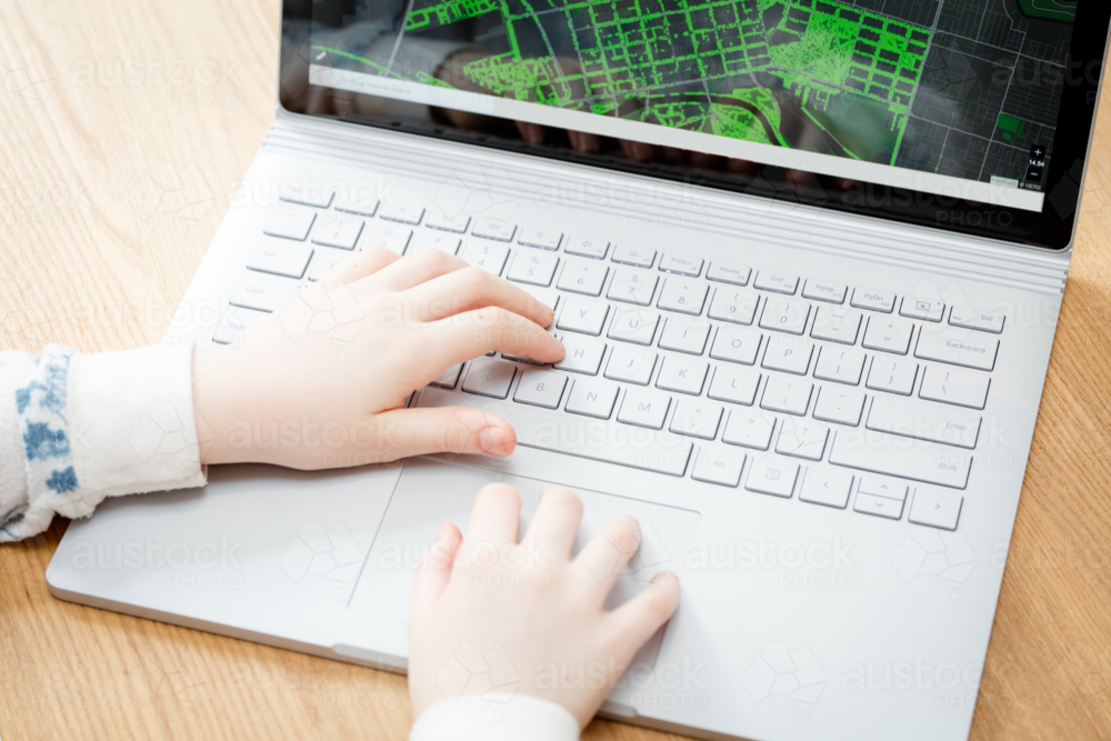 Image of A young female child uses a computer in remote learning for ...
