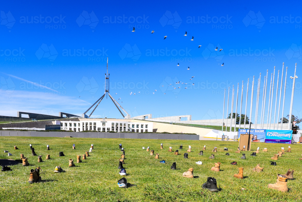 a Zero Suicide Awareness display in Canberra, featuring boots laid out across the lawn - Australian Stock Image
