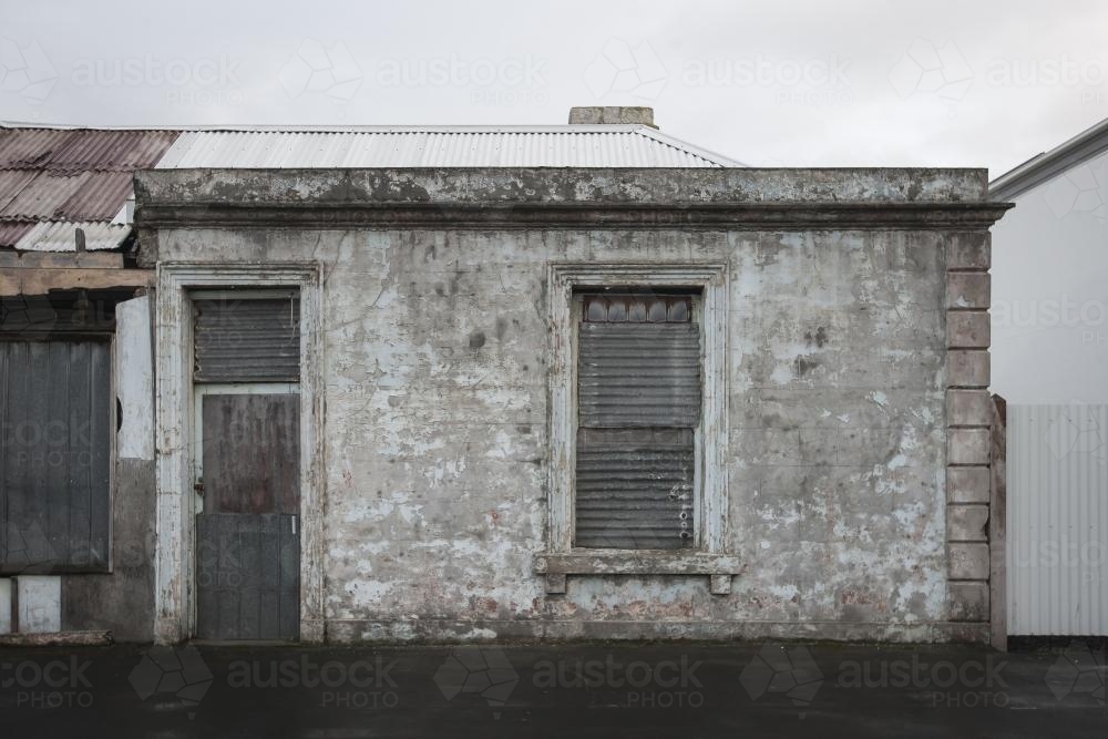 Abandoned grey building on overcast day - Australian Stock Image