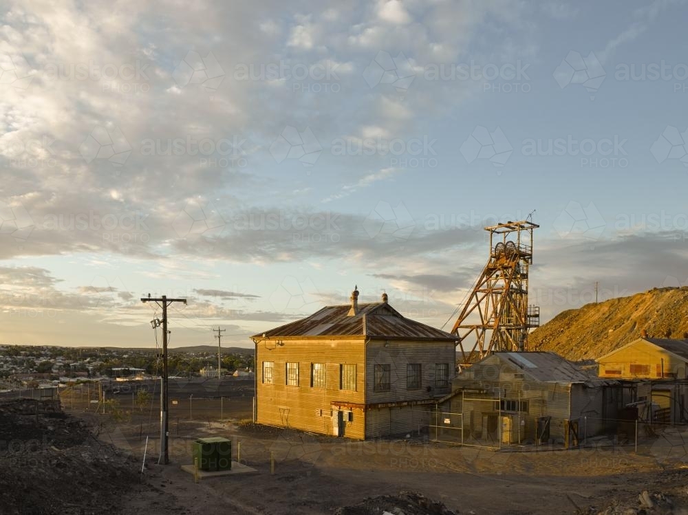 Abandoned poppet head and buildings at a mine site - Australian Stock Image